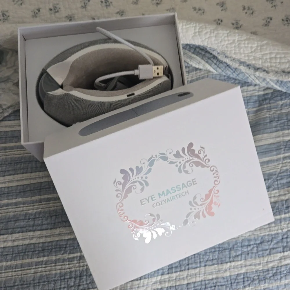 NIB Eye massager for migraines with heat and built-in music.